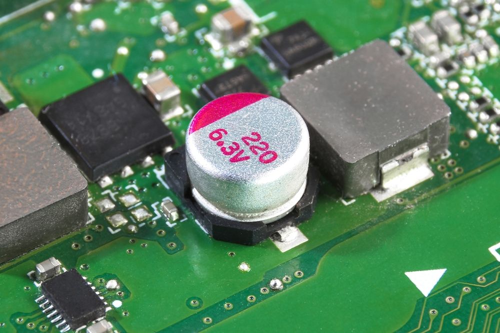 Conductive polymer aluminium solid capacitor or electrolytic capacitor on electronics circuit board of electric appliance , Electronic parts concept