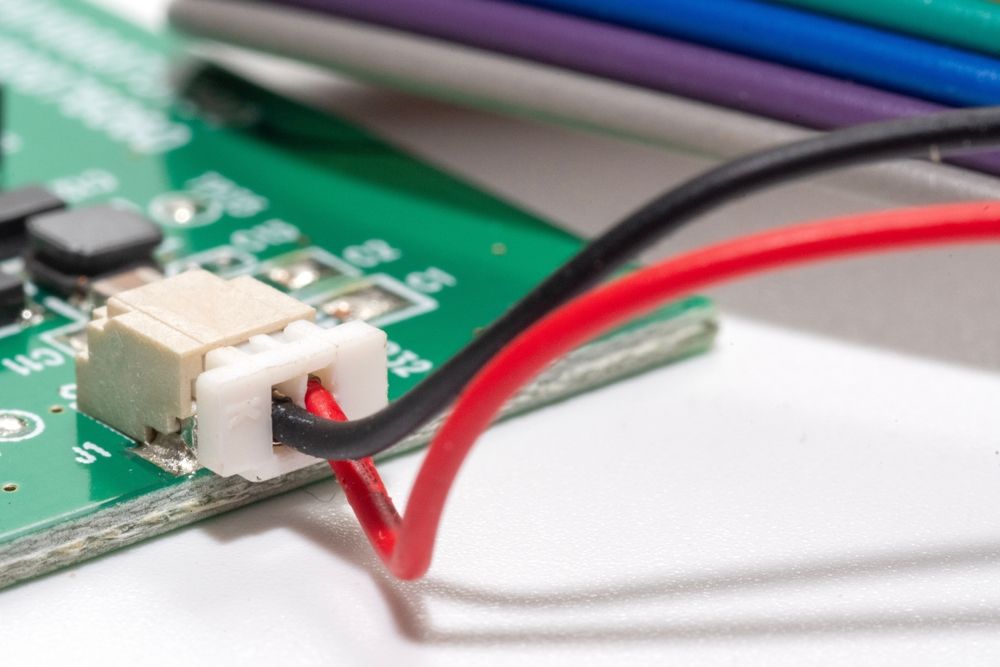 Connector with black and red wire connects to PCB board