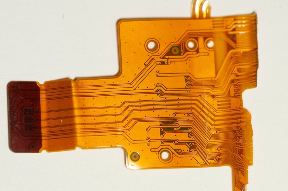 The left end of this flex PCB is stiffened with additional layers of thick polyimide rather than using FR4.