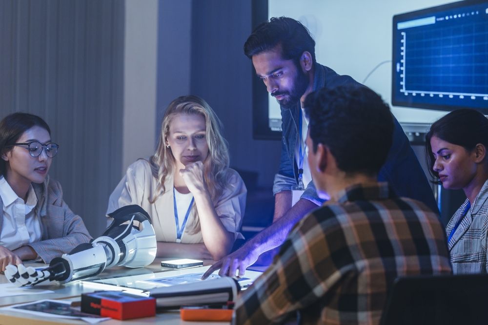 Group of engineers linking test results and customer feedback to design