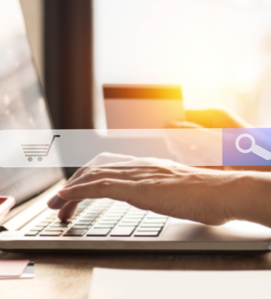 Hands typing in a search on a laptop