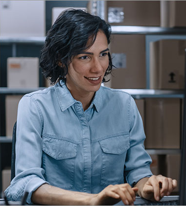 Women working at computer in warehouse