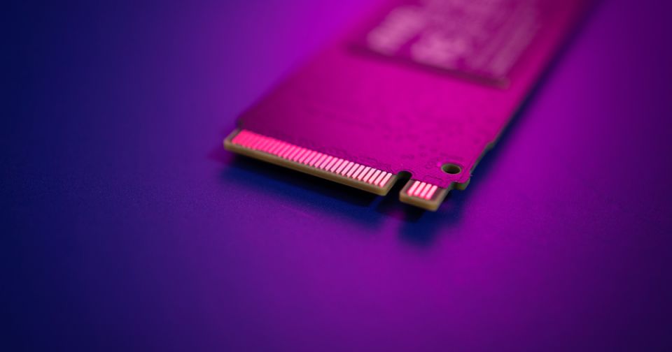 A close-up of an M.2 NVMe SSD showing the gold M-key edge connector, used for high-speed PCIe storage expansion on single-board computers like the Raspberry Pi 5.